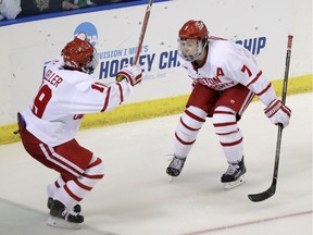 Charlie McAvoy (7) starts to celebrate with Boston University teammate Clayton Keller after scoring an overtime goal for against against the University of North Dakota in an NCAA hockey playoff contest on March 24.