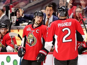 Coach Guy Boucher makes a point to Dion Phaneuf while Erik Karlsson listens in the first overtime period.