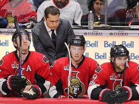 Head coach Guy Boucher stares intently at the proceedings on the ice behind Senators players, left to right, Kyle Turris, Ryan Dzingel and Bobby Ryan during Game 5 against the Bruins at Canadian Tire Centre on Friday night.