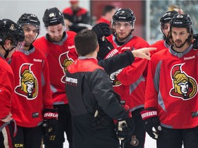 Coach Guy Boucher talks to the players as the Ottawa Senators practice at the Bell Sensplex before the playoffs begin on Wednesday evening.