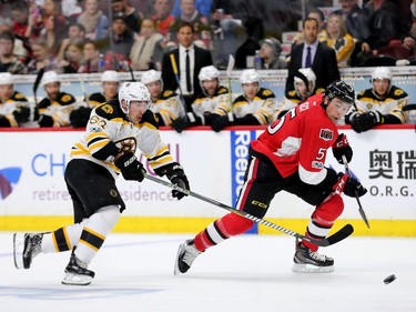 Ottawa's Cody Ceci gets out in front of Brad Marchand in the second period.