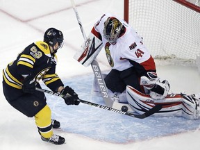 Craig Anderson of the Ottawa Senators stops Brad Marchand during the first period.