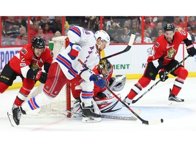 New York Rangers' Mika Zibanejad (93) and Ottawa Senators' Alex Burrows  (14) fights for control of the puck during the second period of Game 6 of  an NHL hockey Stanley Cup second-round