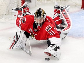 Craig Anderson pounces on a loose puck in the third period as the Ottawa Senators take on the Boston Bruins in game five of round one in the NHL playoffs.  Wayne Cuddington/Postmedia