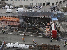 A crane flipped at the construction site of the east entrance of the LRT near Waller and Laurier after failing to lift a truck, in Ottawa on April 26, 2017. Newly released reports show that engine oil, hydraulic oil, transmission oil and antifreeze spilled from the machine, but since the scene was secured by the Ontario Ministry of Labour, no one could clean it up.
