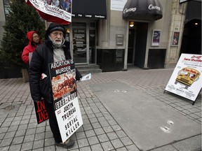 Cy Winter stands on Bank St. just outside The Morgentaler Clinic where he's protested abortions for the past four and a half years Monday December 07, 2015.