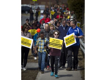 Cyrville Councillor Tim Tierney and Mayor Jim Watson with a group of children, lead the community safety march on Jasmine Crescent Sunday April 9, 2017.   Ashley Fraser/Postmedia