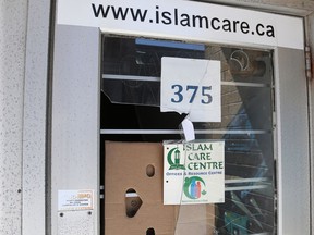 Damage to the front door of the Islam Care Centre at 375 Somerset St. near Bank is covered up with cardboard.