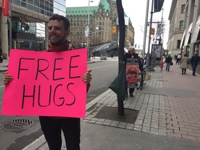Darcy Smith (left), 28, offers free hugs Friday outside the Morgentaler Clinic on Bank Street as a way to counter the anti-abortion protesters who regularly protest outside the clinic.