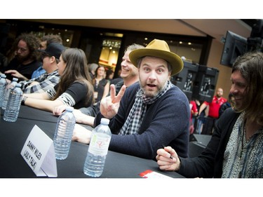 Darryl James of the Strumbellas flashes a peace sign at the Rideau Centre.