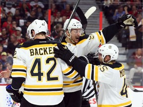 Sean Kuraly celebrates with David Backes, left, and Joe Morrow, right, after scoring the Bruins' second goal of Friday night's game in Ottawa. Jean Levac/Postmedia