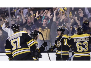 Boston Bruins left wing David Pastrnak, second from right, celebrates his goal off Ottawa Senators goalie Craig Anderson with teammates and fans during the second period in Game 3 of a first-round NHL hockey playoff series in Boston, Monday, April 17, 2017.