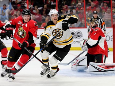 The Senators' Dion Phaneuf tries to hold up David Pastrnak with Craig Anderson looking on in the second period.