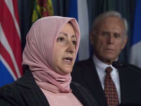 Rania Tfaily, wife of Hassan Diab, a Canadian held in France on terror charges, addresses a news conference Thursday as his Canadian lawyer Don Bayne looks on.