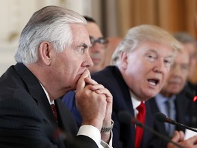 Secretary of State Rex Tillerson, left, listens as President Donald Trump speaks during a bilateral meeting with Chinese President Xi Jinping at Mar-a-Lago, Friday, April 7, 2017, in Palm Beach, Fla. Trump was meeting again with his Chinese counterpart Friday, with U.S. missile strikes on Syria adding weight to his threat to act unilaterally against the nuclear weapons program of China's ally, North Korea.