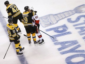 Boston Bruins' Drew Stafford (19) hugs Ottawa Senators' Erik Karlsson (65), of Sweden, after the Senators defeated the Bruins 3-2 during overtime in game six of a first-round NHL hockey Stanley Cup playoff series, Sunday, April 23, 2017, in Boston.