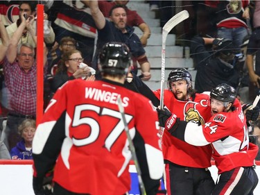 Erik Karlsson of the Ottawa Senators celebrates his goal with Jean-Gabriel Pageau and Tommy Wingels against the New York Rangers during third period of NHL playoff action at the Canadian Tire Centre in Ottawa, April 27, 2017.
