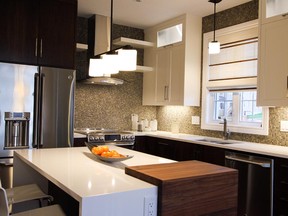 The spacious kitchen in the Clematis model includes a large island breakfast bar and a mosaic tiled backsplash.