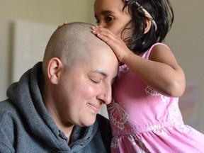 Addison kissing Julia Wagg's head during conditioning chemotherapy before a stem cell transplant in May 2016.