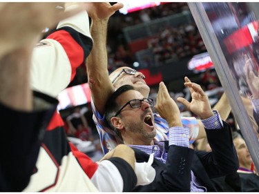 Fans of the Ottawa Senators celebrate their team's first goal against the New York Rangers.