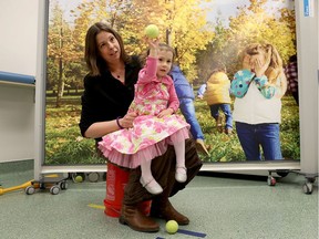 Adeline Mahoney plays with some toys with her mother Sandra at the Children's Hospital of Eastern Ontario (CHEO) in Ottawa Wednesday April 19, 2017. Adeline has congenital heart disease and is taking part of a two-year clinical trial called "Fearless Physical Activity."      Tony Caldwell