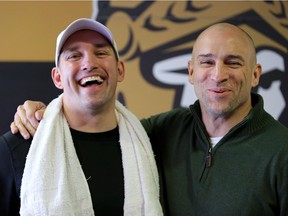 Former Senators teammates Alexandre Daigle, left, and Shawn McEachern share a joke in the lobby between games at the Bell Sensplex on Friday.  Julie Oliver/Postmedia