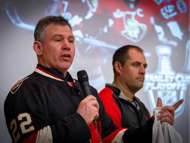 Former Senators player Shaun Van Allen, left, speaks with former player Chris Phillips during a rally at A. Lorne Cassidy Elementary School.