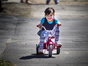 Four year old Serena Commisso was all smiles getting to ride her Radio Flyer trike through Saint Luke's Park off Elgin.