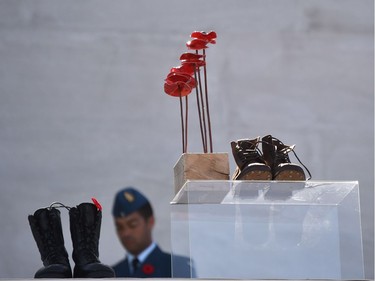 A sculpture of red poppies by artist Bernard Freseau and boots are displayed at the Canadian National Vimy Memorial in Vimy, near Arras, northern France, on April 9, 2017, during a commemoration ceremony to mark the 100th anniversary of the Battle of Vimy Ridge, a World War I battle which was a costly victory for Canada, but one that helped shape the former British colony's national identity.