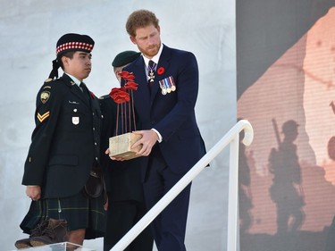 Britain's Prince Harry lays red poppies, at the Canadian National Vimy Memorial in Vimy, near Arras, northern France, on April 9, 2017, during a commemoration ceremony to mark the 100th anniversary of the Battle of Vimy Ridge, a World War I battle which was a costly victory for Canada, but one that helped shape the former British colony's national identity.