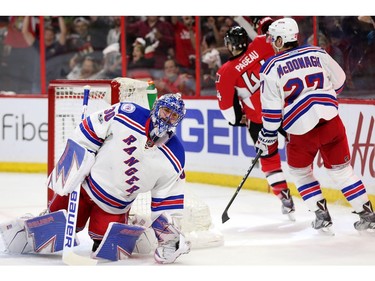 Goalie Henrik Lundqvist looks dejected while Jean-Gabriel Pageau celebrates his goal in the first period.