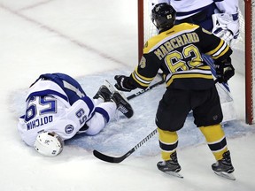 Tampa Bay Lightning defenceman Jake Dotchin lies on the ice after getting speared by the Boston Bruins' Brad Marchand in Boston on Tuesday, April 4, 2017.