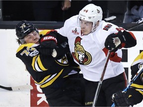 Ottawa Senators center Jean-Gabriel Pageau, right, drops Boston Bruins defenseman Charlie McAvoy to the ice on a hard check during the first period in Game 3 of a first-round NHL hockey playoff series in Boston, Monday, April 17, 2017.