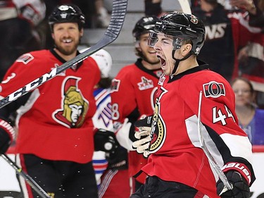 Jean-Gabriel Pageau, with Marc Methot and Mike Hoffman  looking on, celebrates his goal in the first period.