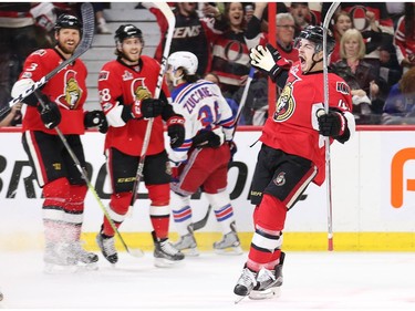 Jean-Gabriel Pageau, with Marc Methot and Mike Hoffman  looking on, celebrates his goal in the first period.