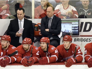 Detroit Red Wings head coach Jeff Blashill, center background, watches his team play against the Ottawa Senators during the first period of an NHL hockey game, Monday, April 3, 2017, in Detroit.