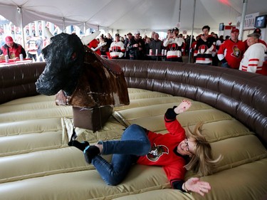 Karen Roberts is tossed off the bull set up in the Red Zone before Game 1.