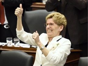 Premier Kathleen Wynne gets a standing ovation after announcing free universal health care to everyone over the age of 24 at Queen's Park Thursday.