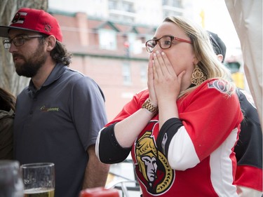 Kristina Maheral couldn't sit down in the overtime of the Senators game against Boston that she watched at St. Louis Bar and Grill on Elgin along Sens Mile Sunday April 23, 2017.   Ashley Fraser/Postmedia