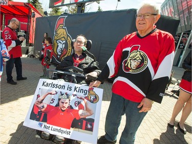 Kyle Rintoul, seen here with his dad Elwood Rintoul, brought his homemade sign, an homage to Erik Karlsson,  to the Red Zone outside Canadian Tire Centre.