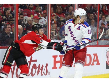 Kyle Turris of the Ottawa Senators hits Marc Staal during the first period.