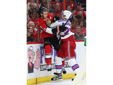 Kyle Turris of the Ottawa Senators is hit hard by Ryan McDonagh of the New York Rangers.