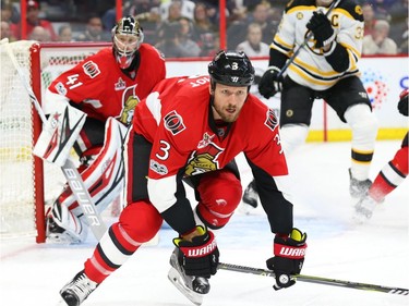 Marc Methot  and Craig Anderson of the Ottawa Senators against the Boston Bruins during second period.