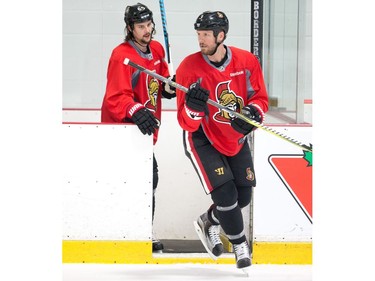 Marc Methot, right, and Erik Karlsson take to the ice as the Ottawa Senators practise at the Bell Sensplex on Friday. The Senators trail the Bruins 1-0 in a best-of-seven series.