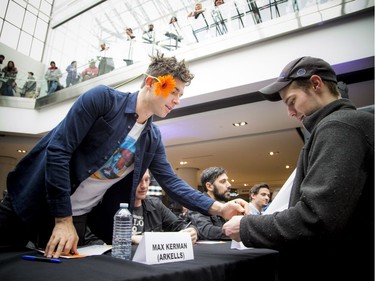 Max Kerman of the Arkells signs Cody Jacobs' shirt.