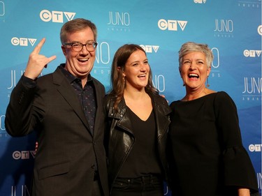 Mayor Jim Watson gives his best rock star pose much to the delight of his niece  Nicola Froislie and sister Jayne Watson as musical talent take to the red carpet at the Juno Awards held on Sunday at the Canadian Tire Centre.