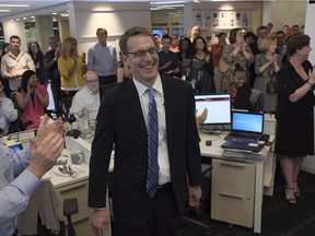 Members of the Washington Post staff congratulate David Fahrenthold, centre, for his Pulitzer Prize for National Reporting in the newsroom of the Washington Post on Monday.