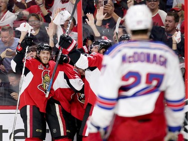 Mike Hoffman looks back at Ryan McDonagh as his fellow Senators celebrate their tying goal in the third period.