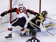 Senators winger Mike Hoffman reaches out to slide the puck past Bruins netminder Tuukka Rask for a breakaway goal in Game 3 in Boston on Monday night.