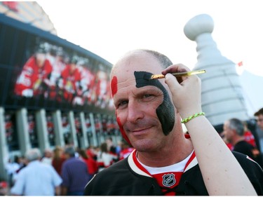 A fan has his face painted prior to the first game of the second round at the Canadian Tire Centre.